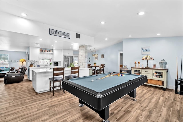 recreation room featuring sink, light hardwood / wood-style flooring, billiards, and lofted ceiling