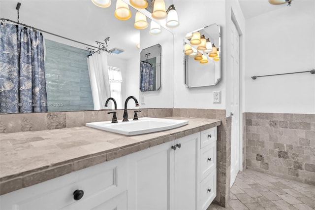 bathroom featuring tile walls and vanity