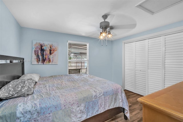 bedroom featuring hardwood / wood-style flooring, ceiling fan, and a closet