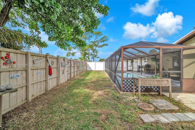 view of yard featuring a fenced in pool and a lanai