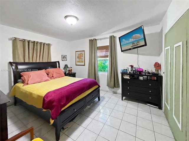 tiled bedroom featuring a textured ceiling