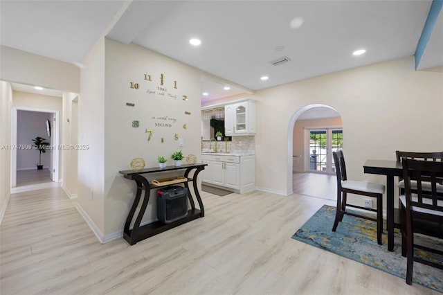 dining room with light wood-type flooring and sink