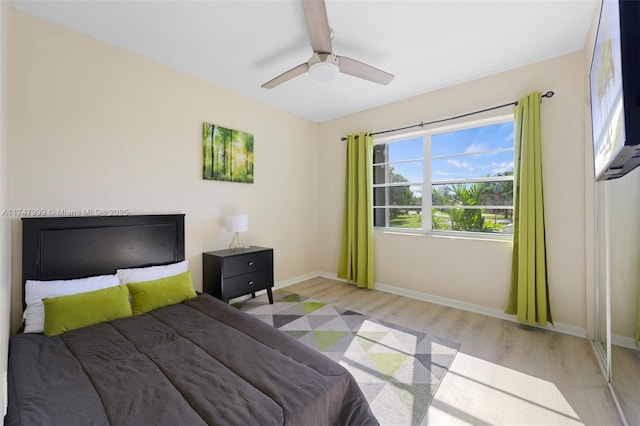 bedroom with ceiling fan and light hardwood / wood-style floors