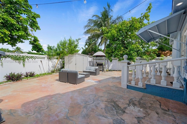 view of patio with a shed, a gazebo, and an outdoor hangout area