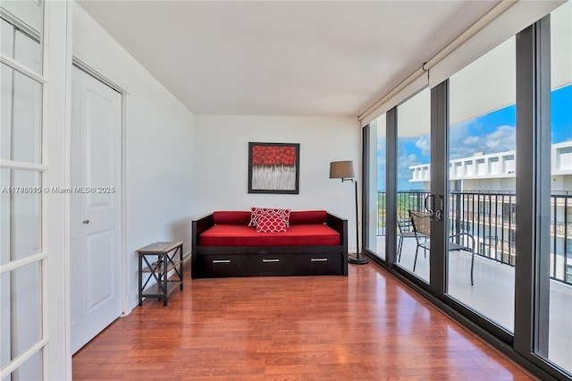 sitting room featuring floor to ceiling windows and wood-type flooring