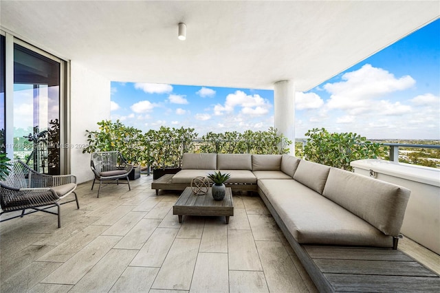 view of patio featuring a balcony and an outdoor hangout area