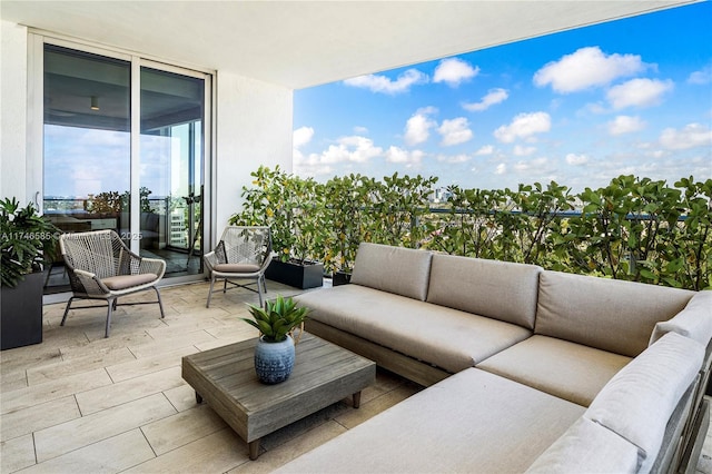 balcony with a patio area and an outdoor living space