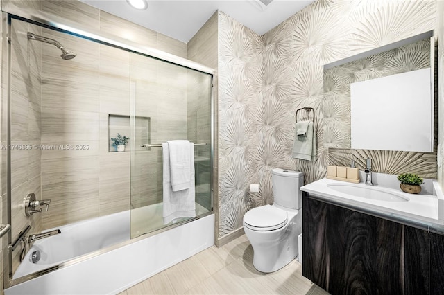 full bathroom featuring enclosed tub / shower combo, vanity, and toilet