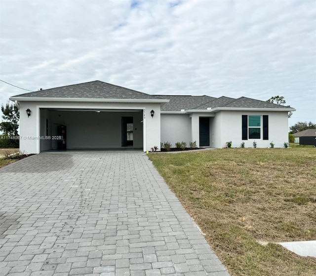 view of front of property featuring a garage and a front lawn