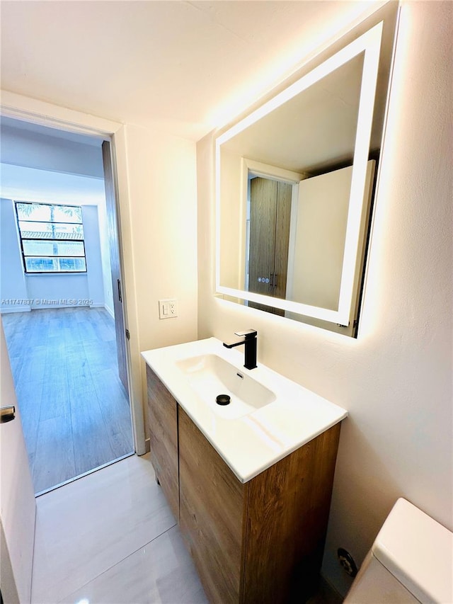 bathroom featuring toilet and vanity