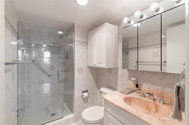 full bath with a shower stall, tile walls, toilet, and vanity