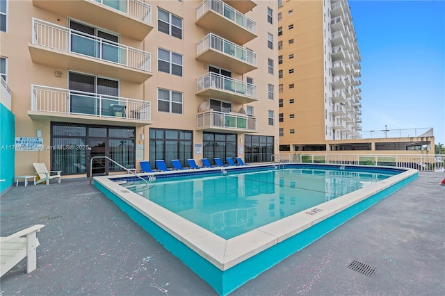 view of swimming pool featuring fence