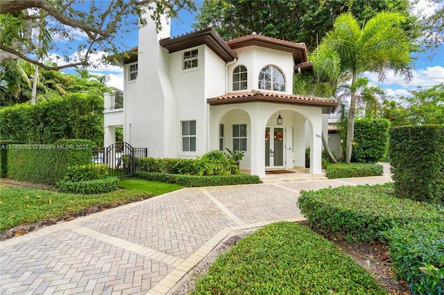 mediterranean / spanish home featuring french doors