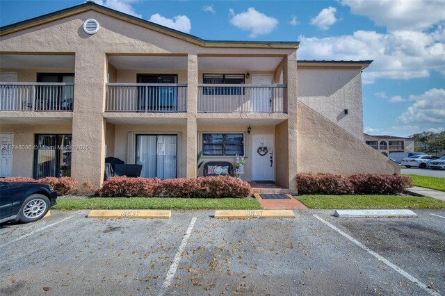 18224 Mediterranean Blvd Unit 5-17, Hialeah, FL 33015 - view of property featuring uncovered parking