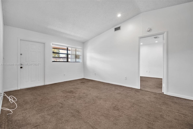 18224 Mediterranean Blvd Unit 5-17, Hialeah, FL 33015 - unfurnished room featuring visible vents, baseboards, dark colored carpet, a textured ceiling, and vaulted ceiling