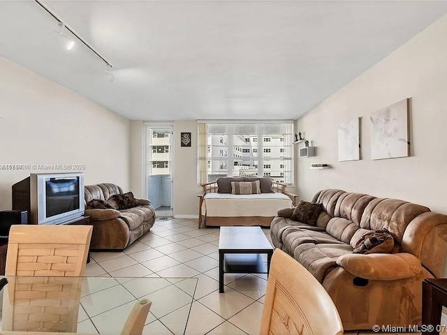 tiled living room featuring track lighting