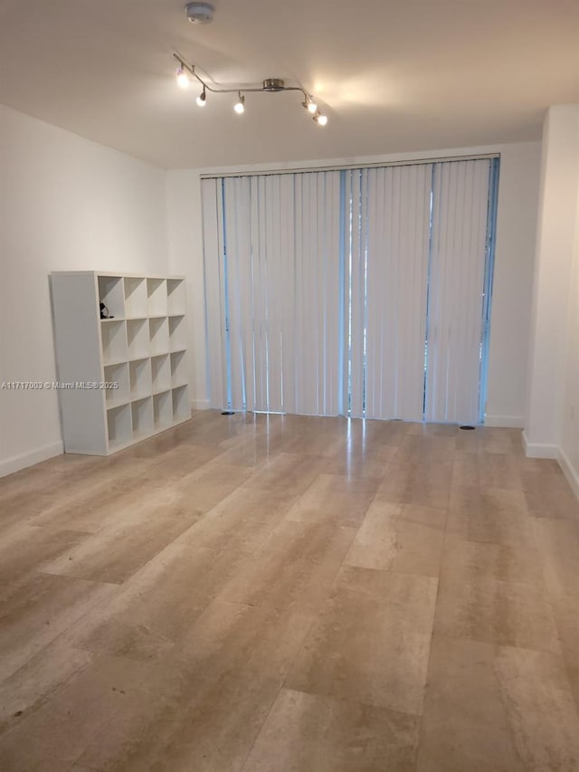 10275 Collins Ave Unit 111, Bal Harbour, FL 33154 - empty room featuring light hardwood / wood-style floors and rail lighting