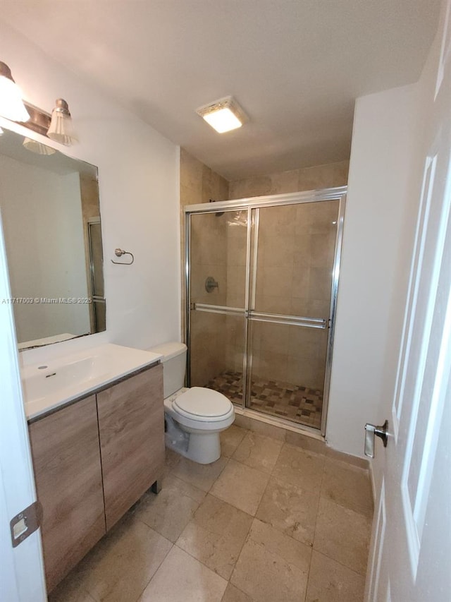 10275 Collins Ave Unit 111, Bal Harbour, FL 33154 - bathroom featuring vanity, toilet, and a shower with shower door