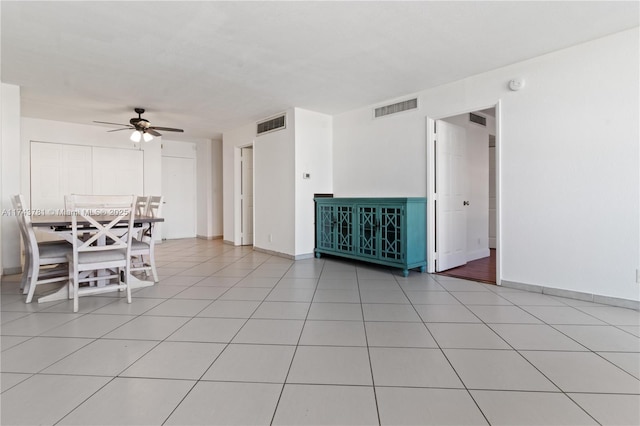 interior space with ceiling fan and light tile patterned flooring