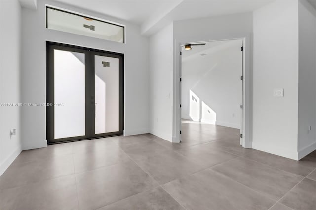 entryway featuring french doors and baseboards