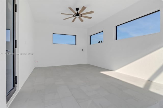 unfurnished room with a ceiling fan