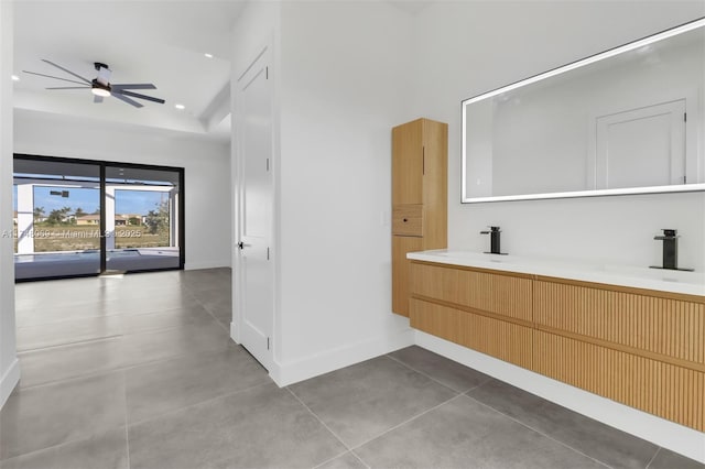 bathroom with ceiling fan, recessed lighting, a sink, baseboards, and double vanity