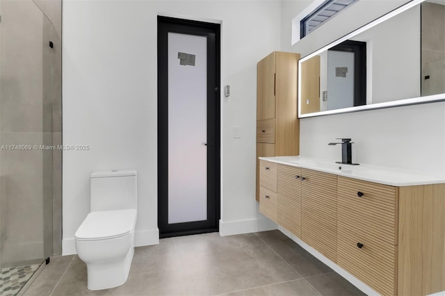 bathroom featuring tile patterned flooring, toilet, vanity, baseboards, and walk in shower