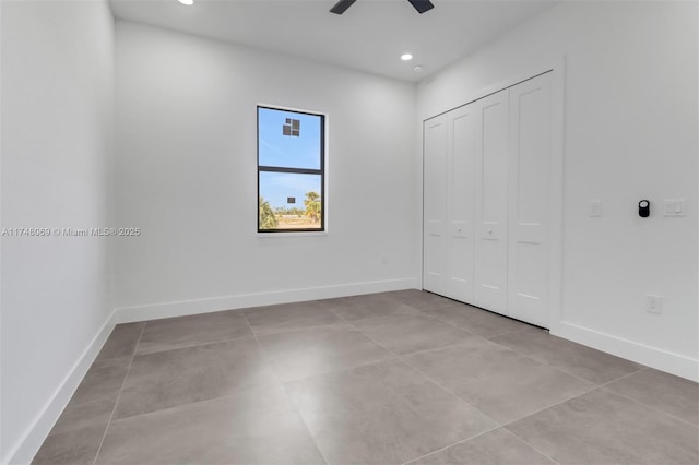 unfurnished bedroom with a closet, recessed lighting, and baseboards