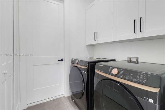 washroom featuring tile patterned flooring, cabinet space, and separate washer and dryer