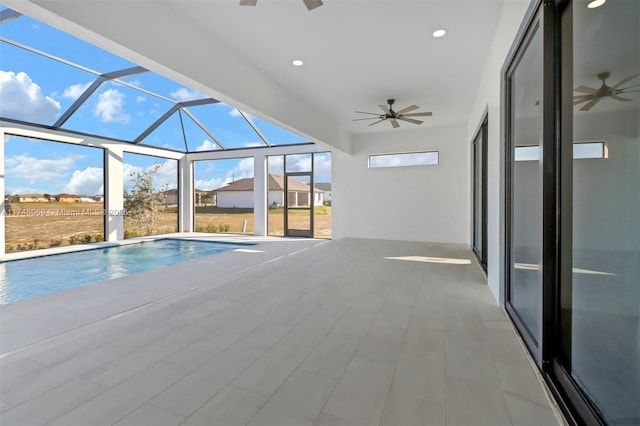 pool featuring a lanai, a patio area, and a ceiling fan