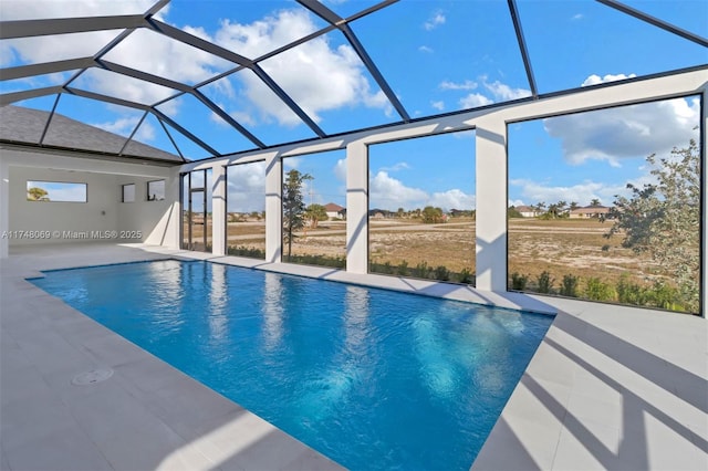 pool featuring glass enclosure and a patio