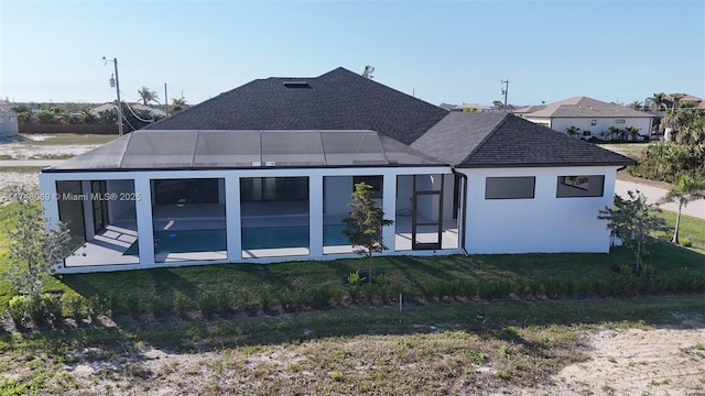 back of property with a shingled roof, an outdoor pool, a lawn, a patio, and a lanai