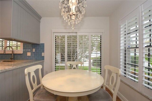 8639 Eagle Run Dr Unit 11, Boca Raton, FL 33434 - dining room with healthy amount of natural light, a chandelier, and baseboards