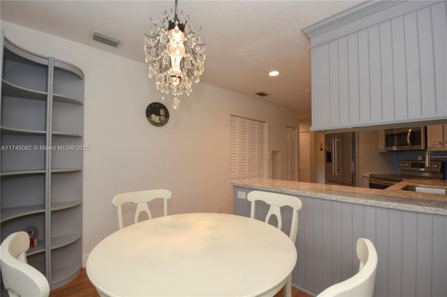 8639 Eagle Run Dr Unit 11, Boca Raton, FL 33434 - dining area with recessed lighting, a chandelier, and wood finished floors