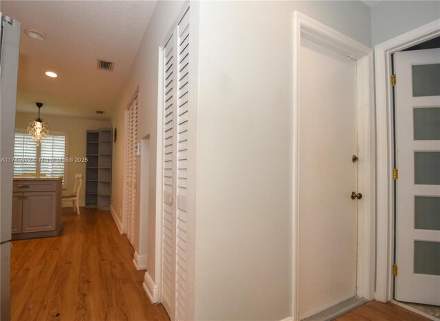 8639 Eagle Run Dr Unit 11, Boca Raton, FL 33434 - hall with recessed lighting, light wood-style floors, a chandelier, and baseboards