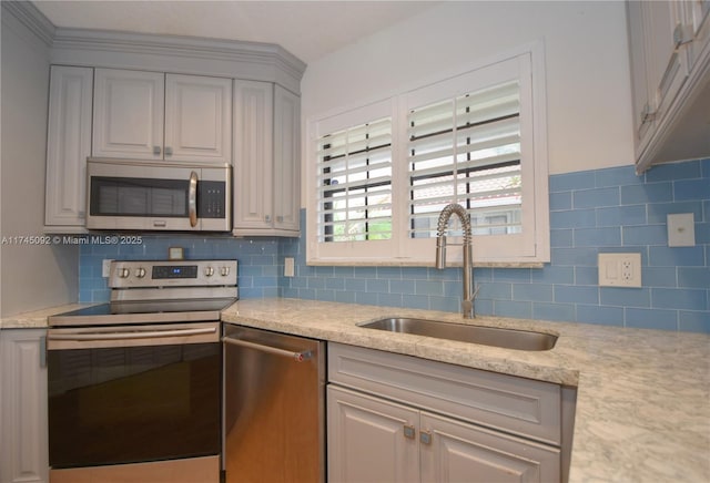 8639 Eagle Run Dr Unit 11, Boca Raton, FL 33434 - kitchen with appliances with stainless steel finishes, a sink, backsplash, gray cabinets, and light stone countertops