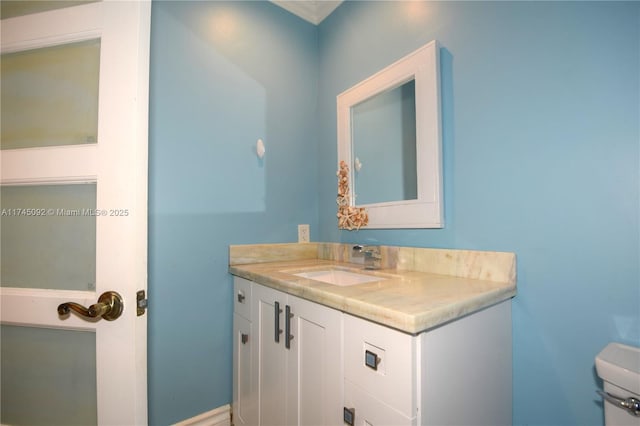 half bath featuring toilet and vanity