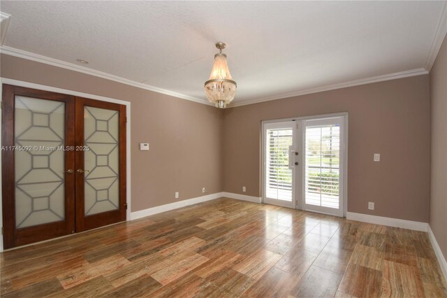 8639 Eagle Run Dr Unit 11, Boca Raton, FL 33434 - spare room with french doors, wood finished floors, baseboards, a chandelier, and ornamental molding