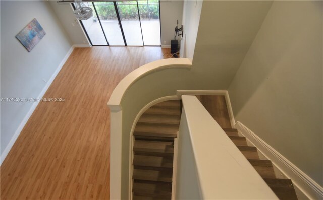 8639 Eagle Run Dr Unit 11, Boca Raton, FL 33434 - stairway with baseboards and wood finished floors