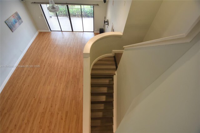 8639 Eagle Run Dr Unit 11, Boca Raton, FL 33434 - stairway featuring wood finished floors and baseboards