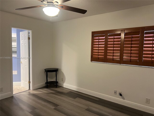 8639 Eagle Run Dr Unit 11, Boca Raton, FL 33434 - empty room featuring dark wood-style flooring, ceiling fan, and baseboards