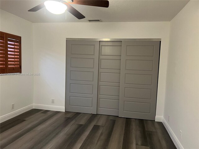 8639 Eagle Run Dr Unit 11, Boca Raton, FL 33434 - unfurnished bedroom featuring dark wood finished floors, baseboards, and ceiling fan