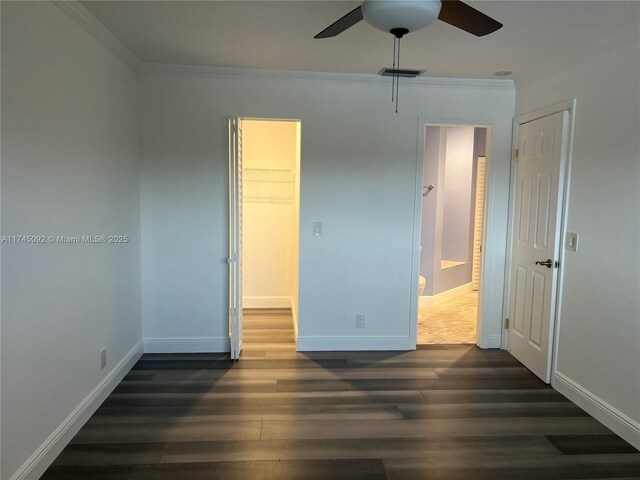 8639 Eagle Run Dr Unit 11, Boca Raton, FL 33434 - unfurnished bedroom featuring ornamental molding, dark wood-type flooring, baseboards, a spacious closet, and a ceiling fan