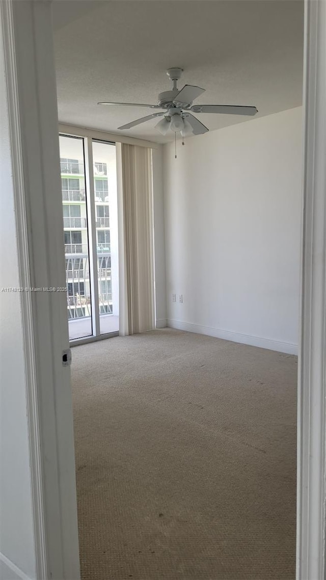 spare room featuring carpet and ceiling fan