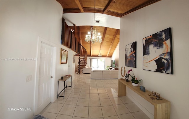 hall with a chandelier, light tile patterned floors, wood ceiling, stairs, and beam ceiling