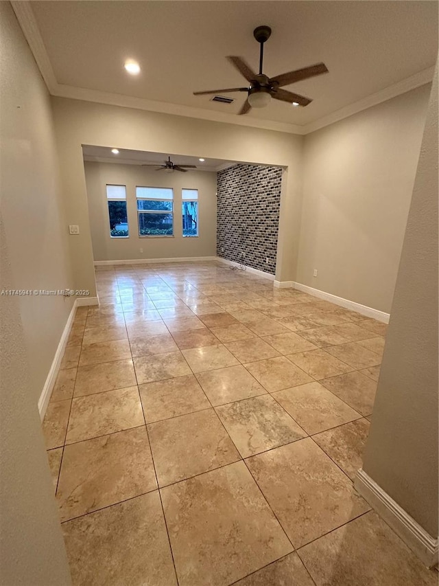 spare room featuring ceiling fan, ornamental molding, and light tile patterned flooring