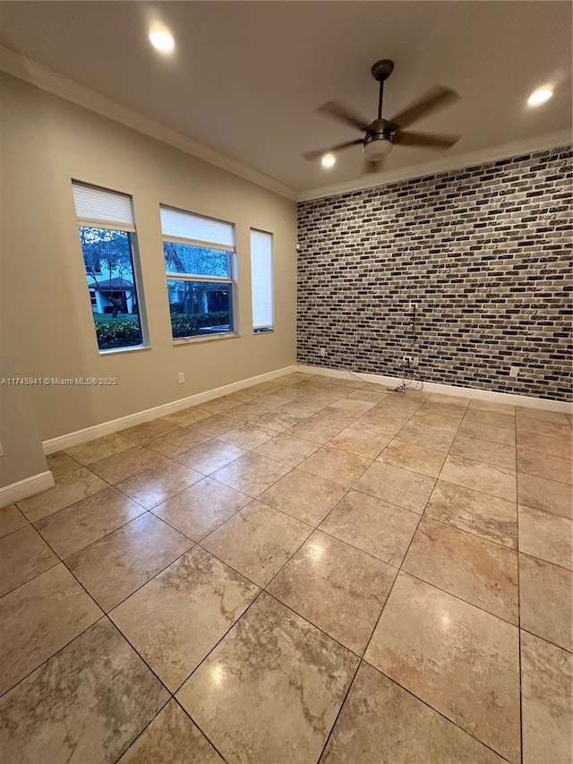 tiled spare room with ceiling fan, brick wall, and crown molding