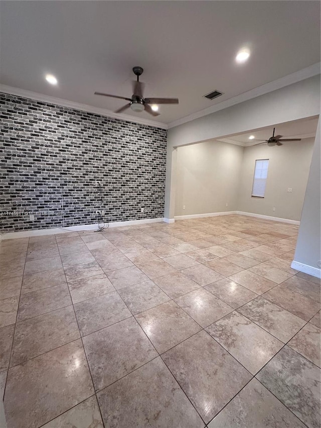 tiled spare room featuring ceiling fan and ornamental molding