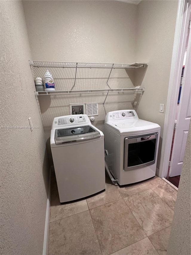 clothes washing area featuring separate washer and dryer