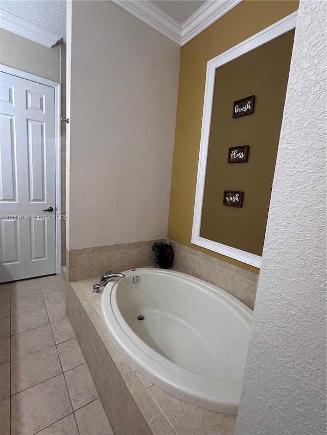 bathroom with tile patterned floors, ornamental molding, and a relaxing tiled tub